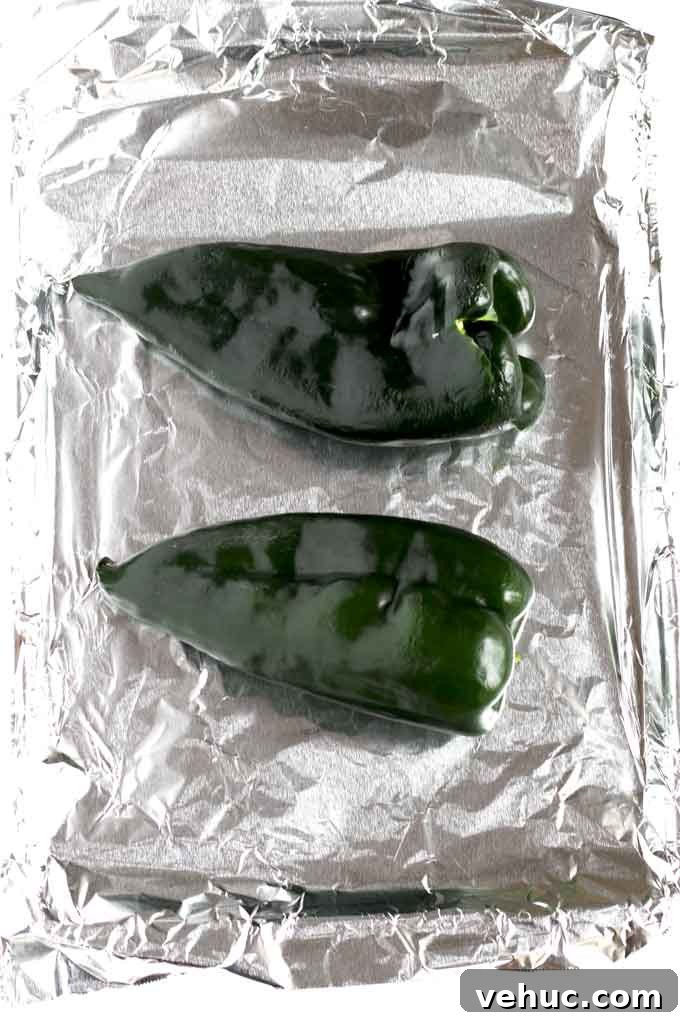 Roasted Poblano and Corn Chowder with Smoky Creaminess 13 Green Poblano Peppers on a baking sheet.