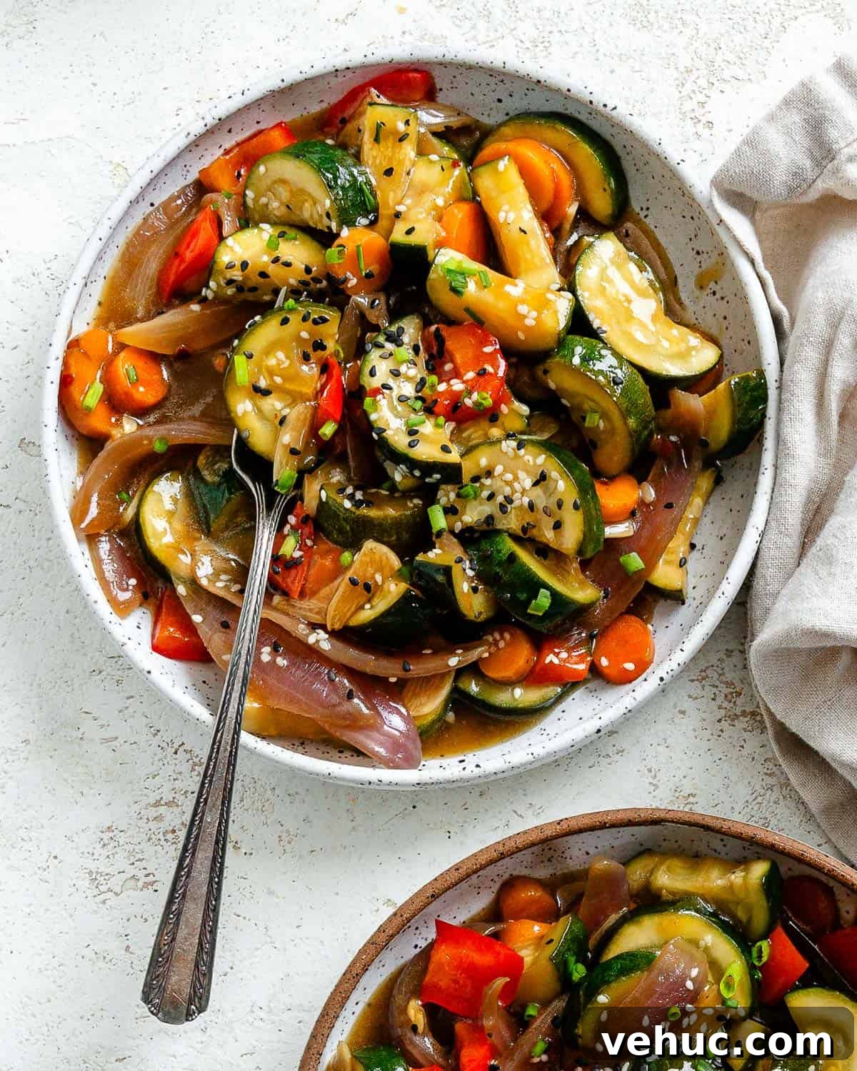 Crispy Garlic Zucchini Stir-Fry Recipe for Weeknight Meals 2 completed Easy Zucchini Stir Fry in two separate bowls