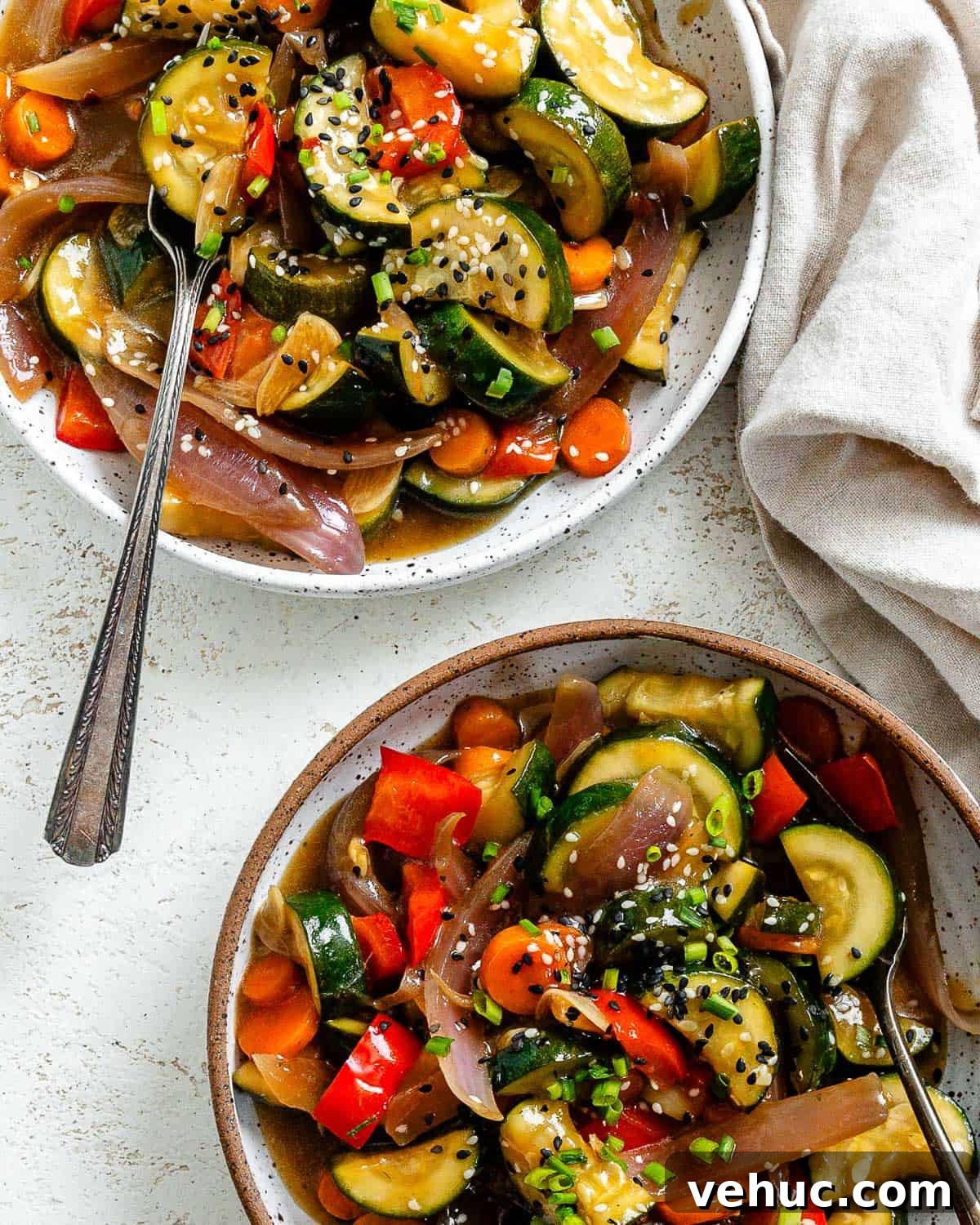 Crispy Garlic Zucchini Stir-Fry Recipe for Weeknight Meals 9 completed Easy Zucchini Stir Fry in two separate bowls