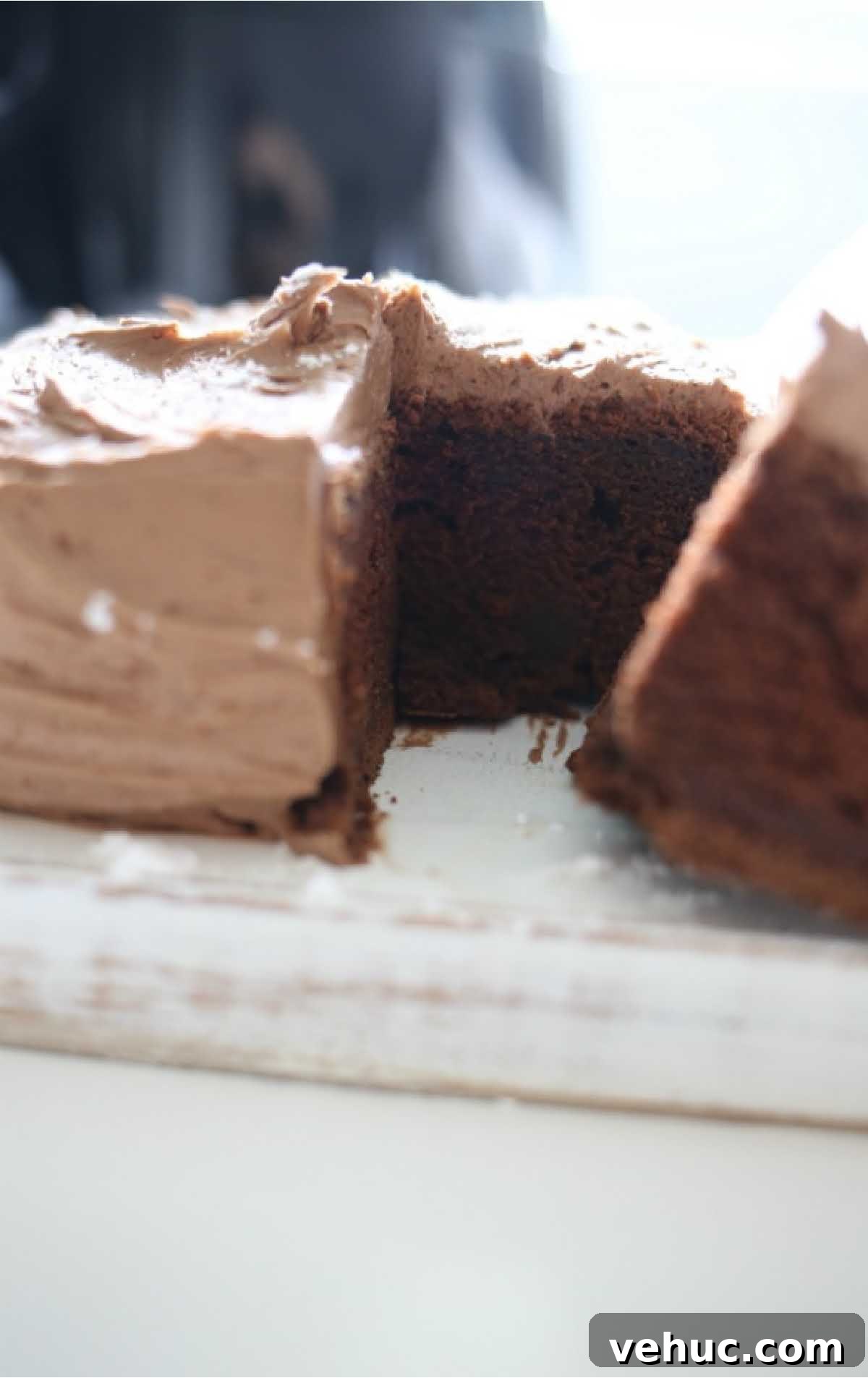 close up shot of Air Fryer Chocolate Cake with a slice being taken out