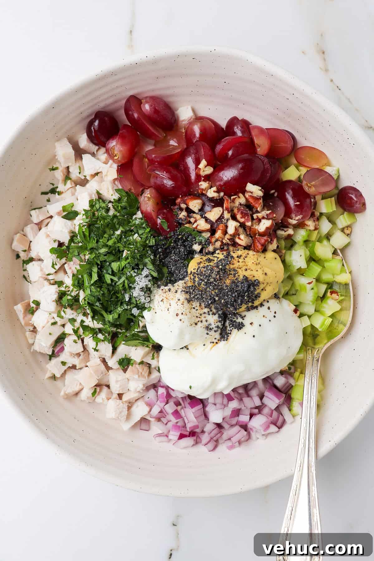 Chocken salad ingredients in a mixing bowl.