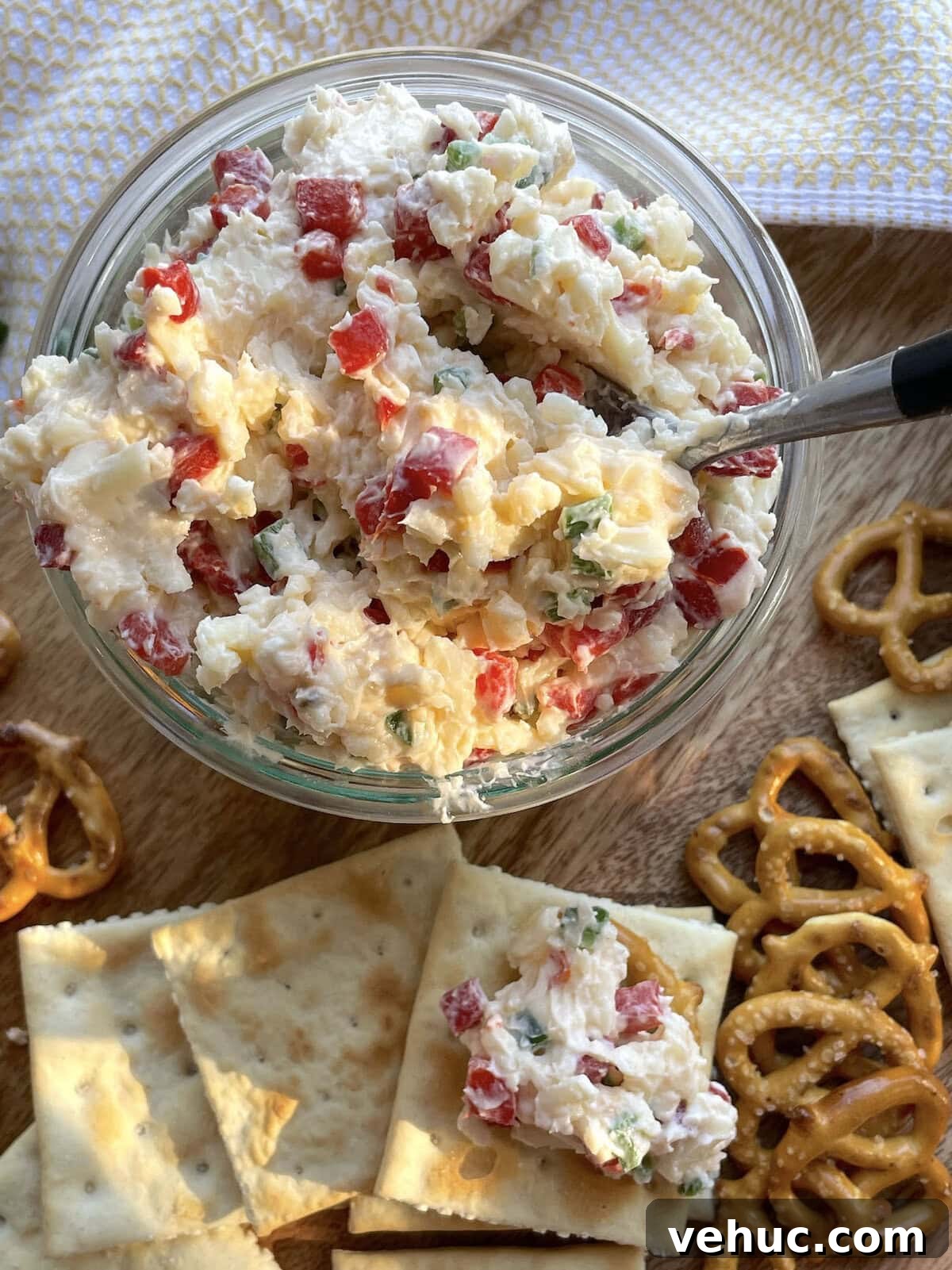 Spicy Jalapeño Pimento Cheese Dip Recipe for Parties 9 A jar of spicy pimento cheese surrounded by saltines and pretzels.