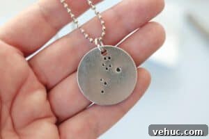 How to Make Stamped Constellation Necklaces (Video) 21 hand holding finished constellation necklace
