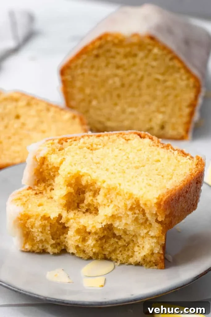 Moist Gluten-Free Pound Cake with Rich Buttery Flavor 2 A slice of gluten free lemon pound cake with vanilla glaze on a plate