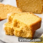 Moist Gluten-Free Pound Cake with Rich Buttery Flavor 13 gluten free pound cake stacked on top of each other on white plate to show soft and buttery texture