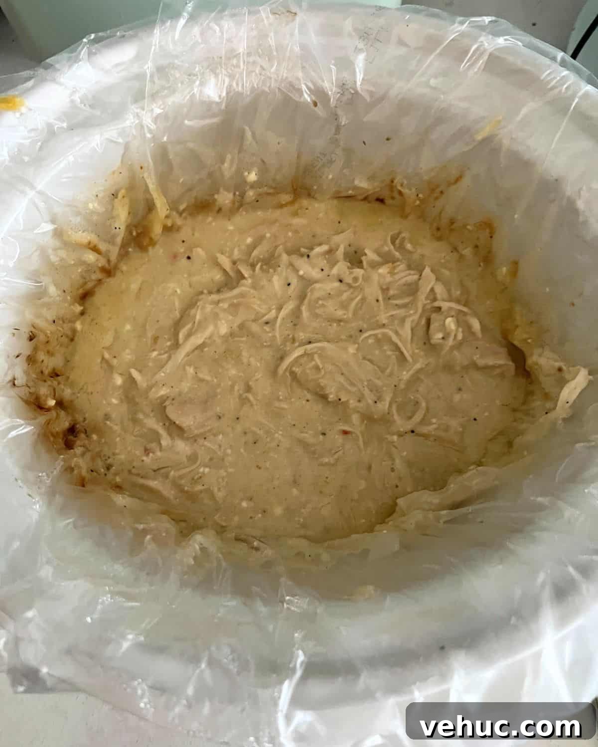 Creamy Italian Crock Pot Chicken Recipe for Tender Slow-Cooked Chicken 5 Shredded chicken in a crock pot.