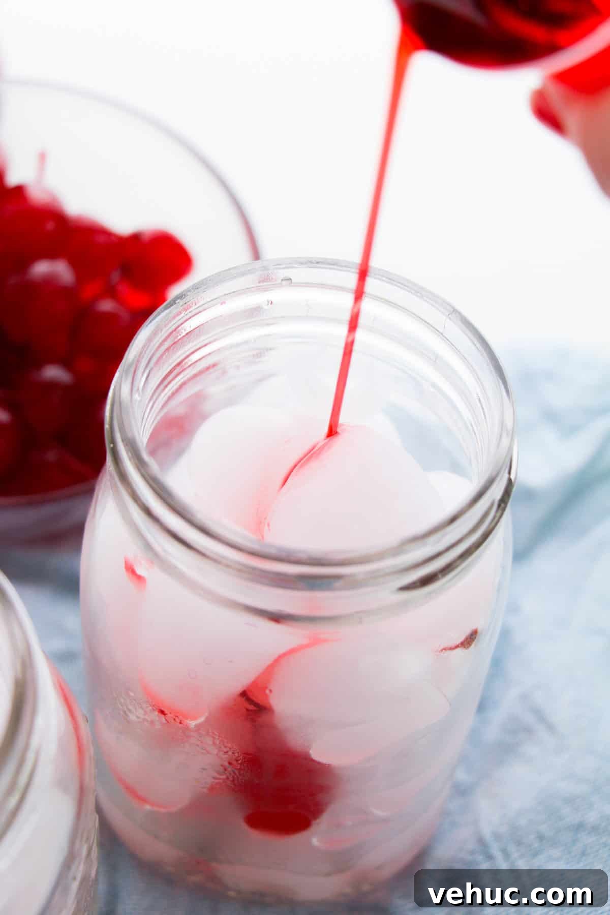 Shirley Temple Dirty Soda Recipe — Sparkling Cherry Lime Mocktail 4 Grenadine being poured into ice-filled mason jar.
