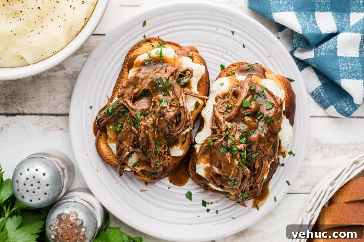 Overhead shot of hot roast beef sandwiches on a plate.