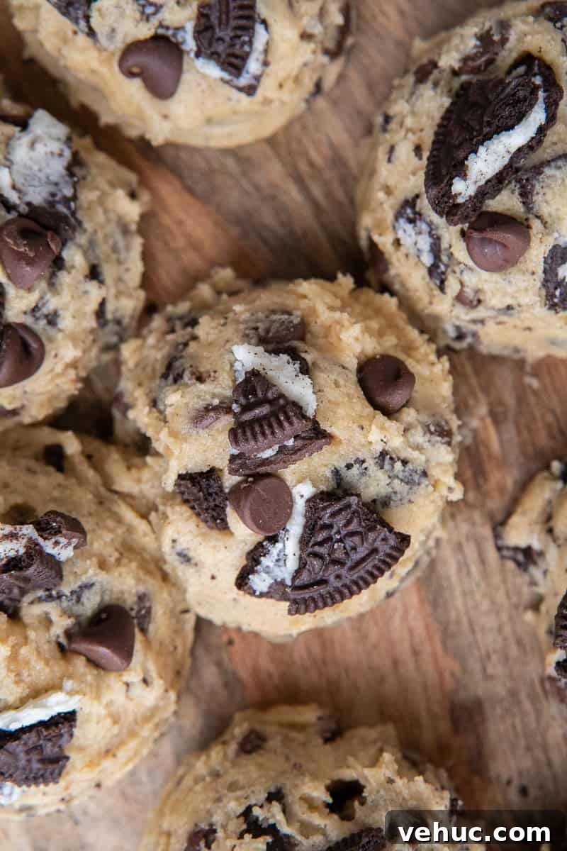 Scooped cookie dough on wooden board
