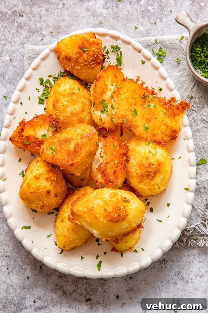 Top down view of parmesan crusted potatoes with chives on a platter