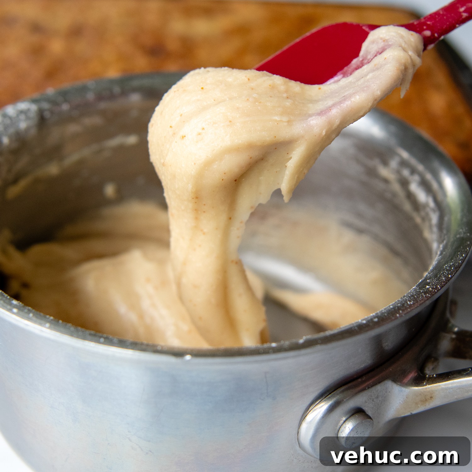 Gluten-Free Banana Bars with Creamy Frosting 6 a spoon holding up the frosting to show consistency.