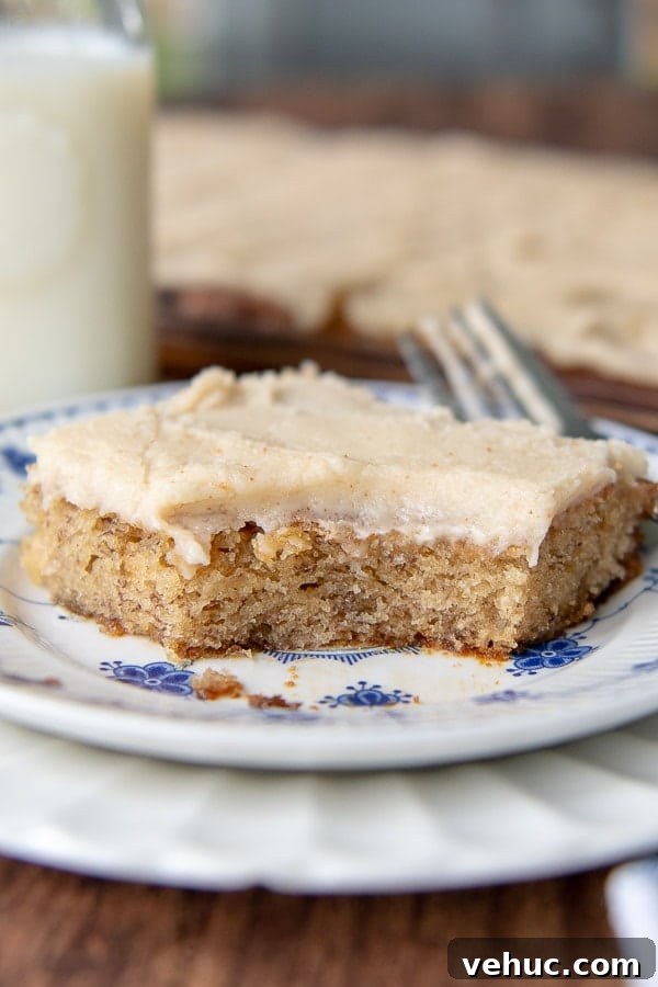 Gluten-Free Banana Bars with Creamy Frosting 7 a sliced bar on a white plate with a big bite taken out.