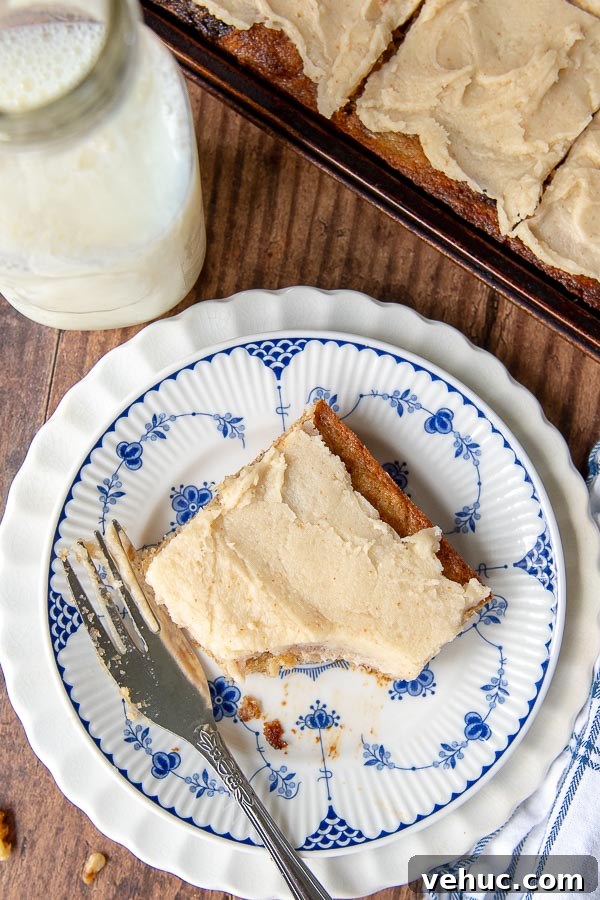 Gluten-Free Banana Bars with Creamy Frosting 8 an overhead shot of banana bread bar on a white and blue plate with a bite taken out