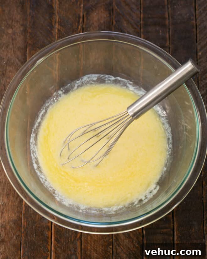 Moist Buttermilk Corn Muffins Recipe for Perfect Breakfast 4 Melted butter, milk, buttermilk and egg mixed in a bowl.
