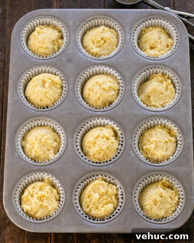 Moist Buttermilk Corn Muffins Recipe for Perfect Breakfast 7 Muffin dough scooped into muffin tin, then baked.