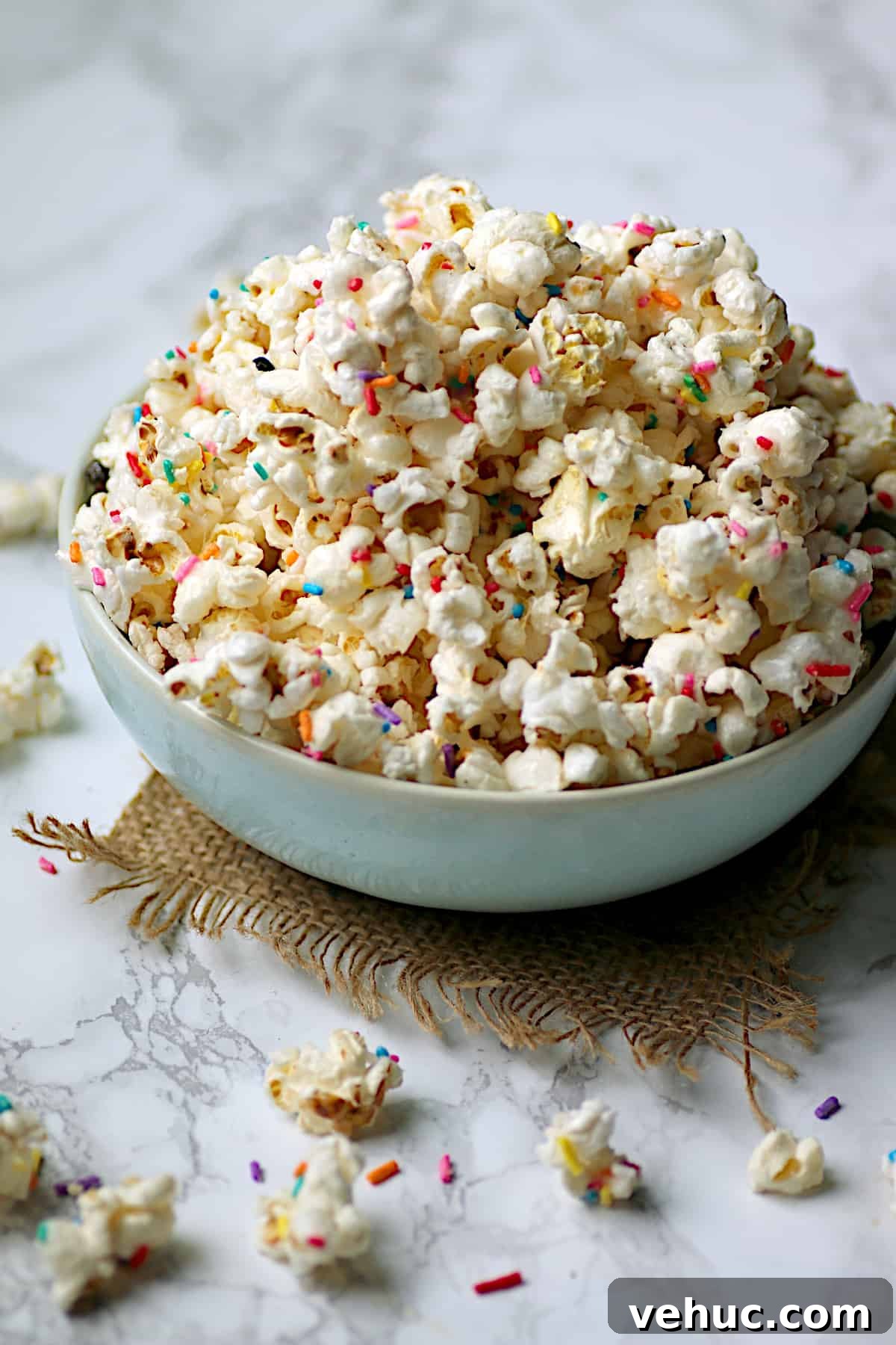 Funfetti Marshmallow Rice Krispie Squares Recipe 5 Homemade funfetti popcorn in a pale blue bowl.