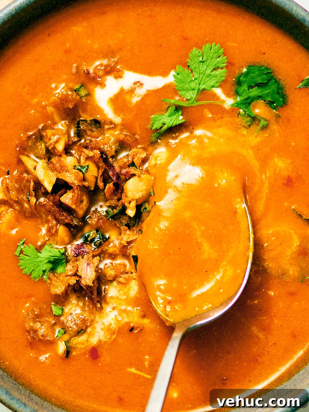 Creamy Kabocha Squash and Coconut Milk Soup — No Blender Needed 14 Kabocha squash soup in a bowl with coconut milk, Peanut Lime Crunch topping, and cilantro.