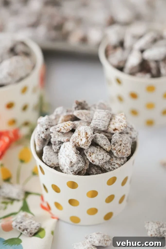 Nutella Muddy Buddies Recipe: Chocolate Hazelnut Snack Mix 2 Nutella Muddy Buddies in small party cups on a tabletop.