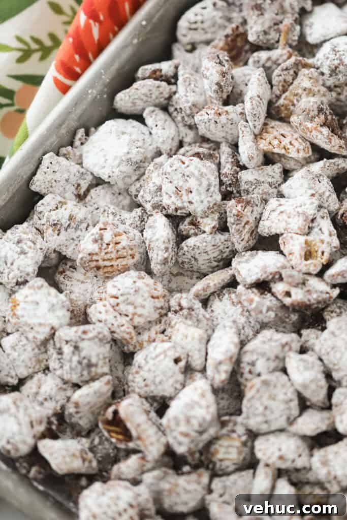 Nutella Muddy Buddies Recipe: Chocolate Hazelnut Snack Mix 4 A baking sheet covered with a layer of muddie buddies.