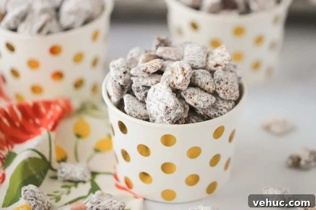 Nutella Muddy Buddies Recipe: Chocolate Hazelnut Snack Mix 5 A small individual cup with gold dots filled with muddy buddies.