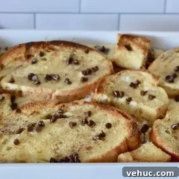 Baked Cannoli French Toast Recipe for a Sweet Brunch 11 cannoli baked French toast in a white casserole dish.