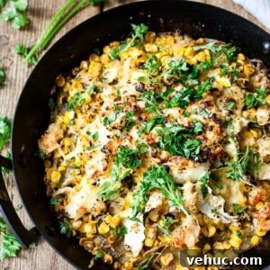 Easy potato bake in a cast iron pan with cheese and parsley.