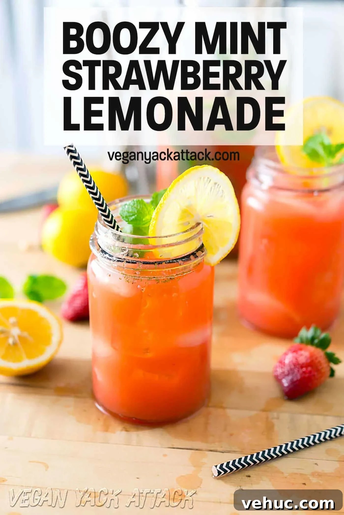 Strawberry Mint Vodka Lemonade Cocktail Recipe 2 A couple of glasses of boozy mint strawberry lemonade next to a large jar of it