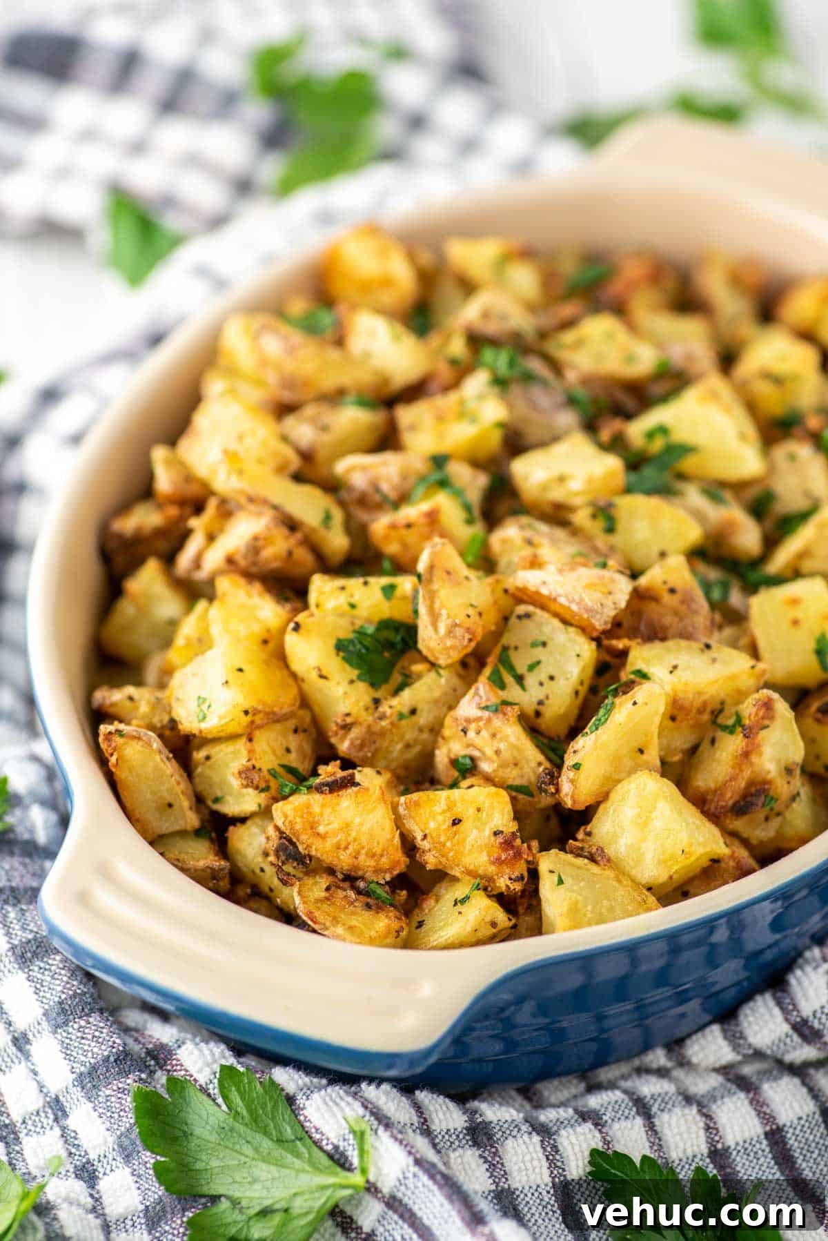 Crispy roasted potatoes in blue oval dish.