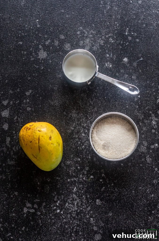 Creamy Mango Milkshake Recipe — Refreshing Tropical Drink 3 ingredients for mango milkshake arranged on a board