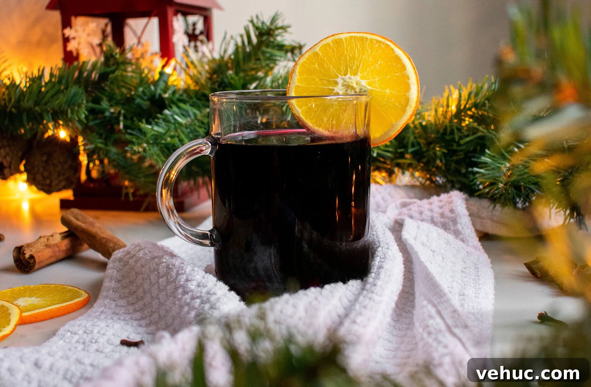 A glass of mulled wine with an orange slice.