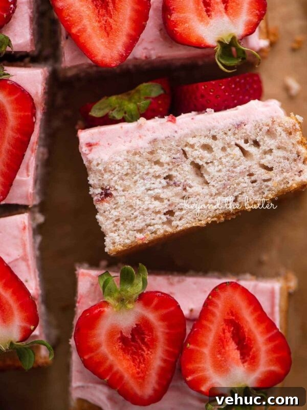 Classic Four-Egg Yellow Sheet Cake with Chocolate Frosting 8 Slices of mini strawberry sheet cake topped with strawberry buttercream frosting and fresh strawberries with one slice on its side.