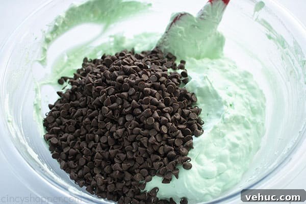 Folding in mini chocolate chips to green dip