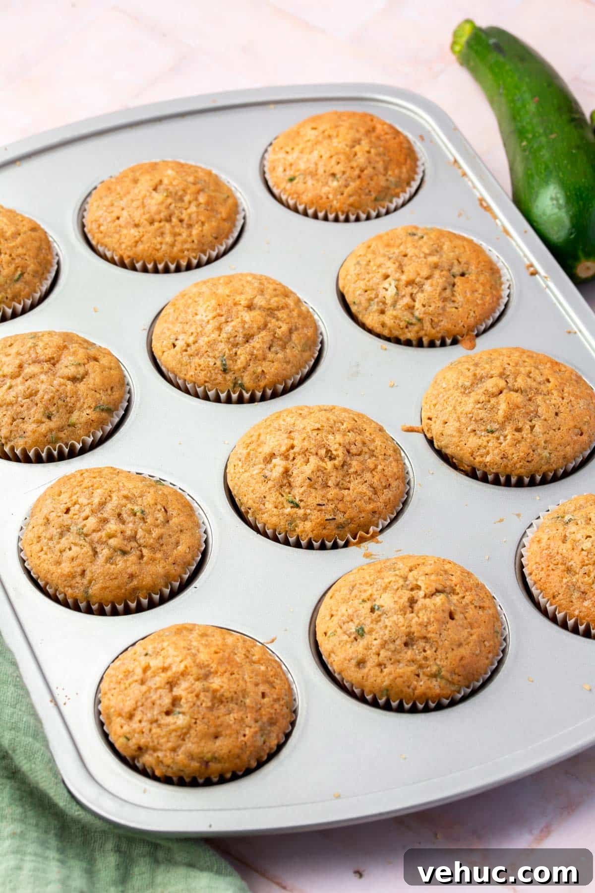Moist Gluten-Free Zucchini Muffins with Cinnamon Oil-Free Option 10 Baked gluten-free zucchini muffins in a muffin tin.