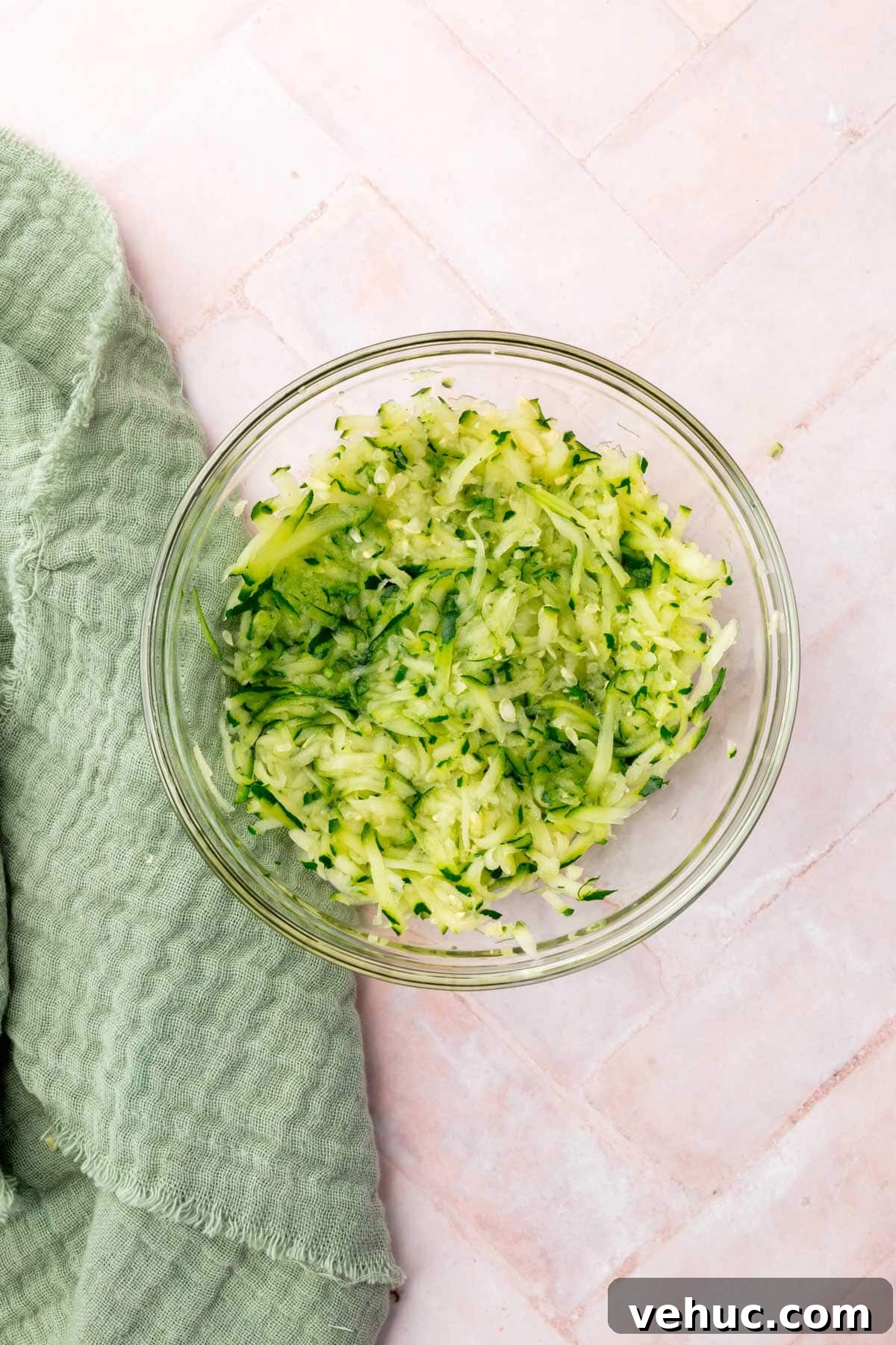 Moist Gluten-Free Zucchini Muffins with Cinnamon Oil-Free Option 4 A glass bowl of shredded zucchini.