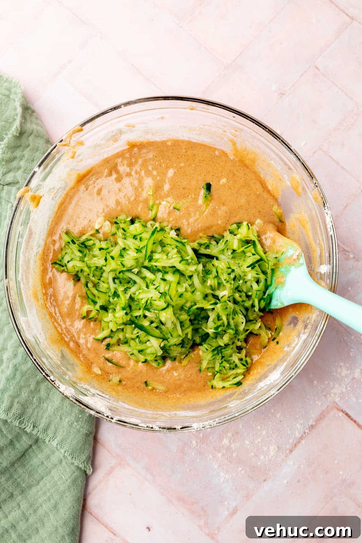Moist Gluten-Free Zucchini Muffins with Cinnamon Oil-Free Option 8 Adding shredded zucchini into the batter.