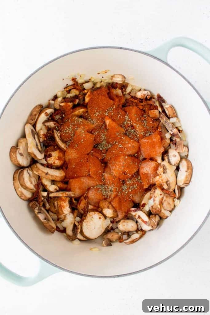 Creamy Chicken Pasta with Mushrooms, Sun-Dried Tomatoes & Spinach 5 dutch oven with chicken cubes with paprika and dried basil