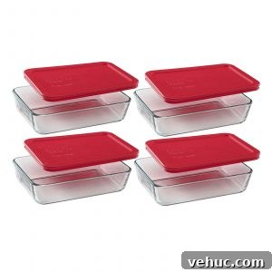 3 cup glass pyrex containers with red lids.