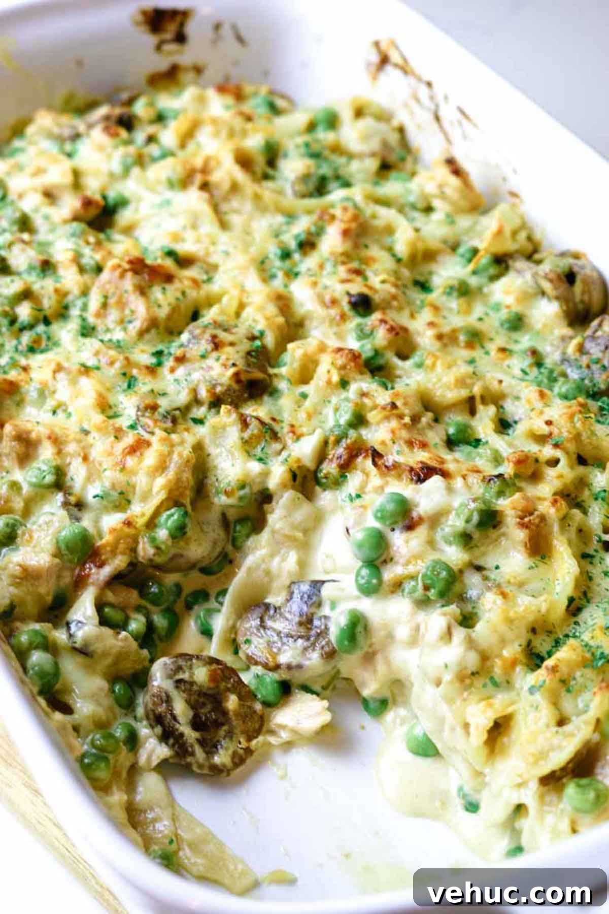 Tuna Noodle Casserole from Scratch (No Canned Soup) 2 tuna noodle casserole with serving scooped out.