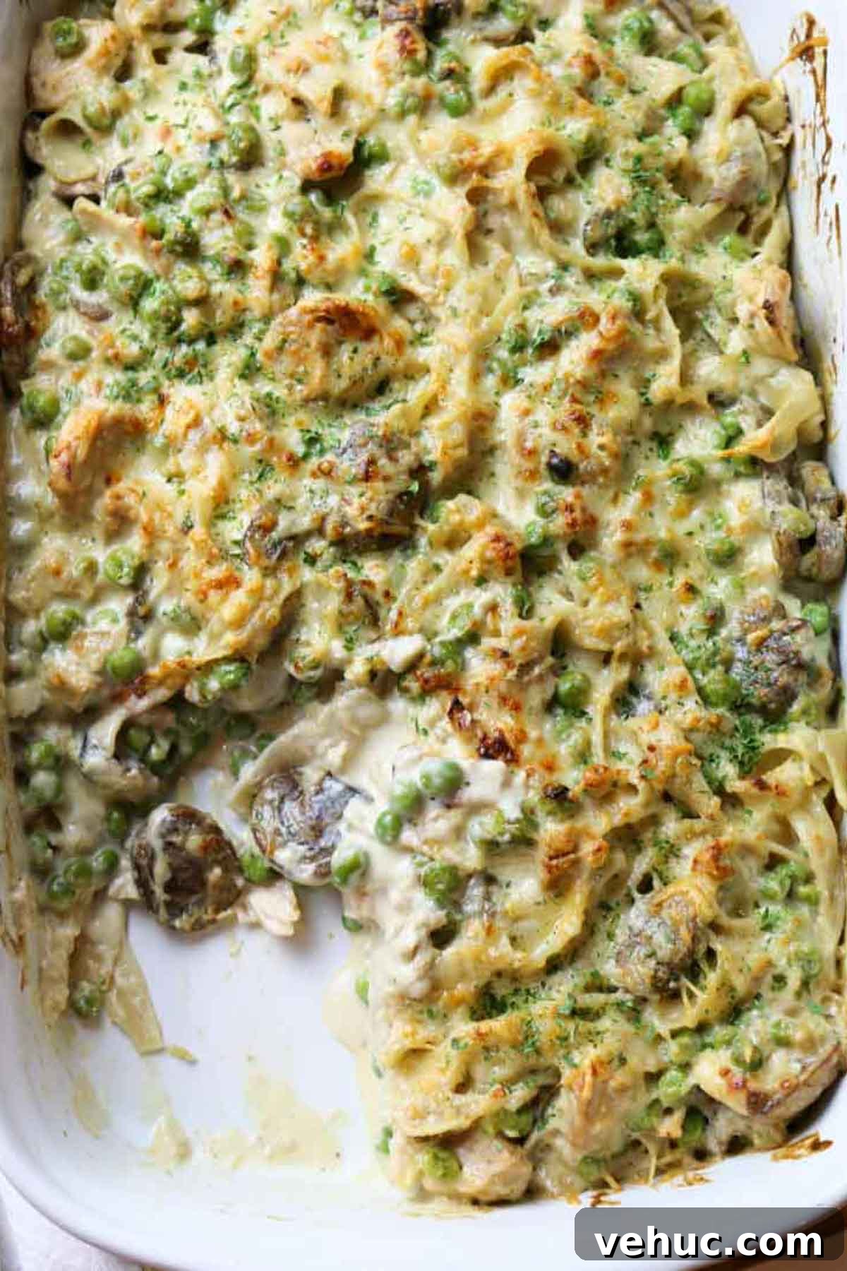 Tuna Noodle Casserole from Scratch (No Canned Soup) 12 tuna noodle casserole with mushrooms and peas in white dish.