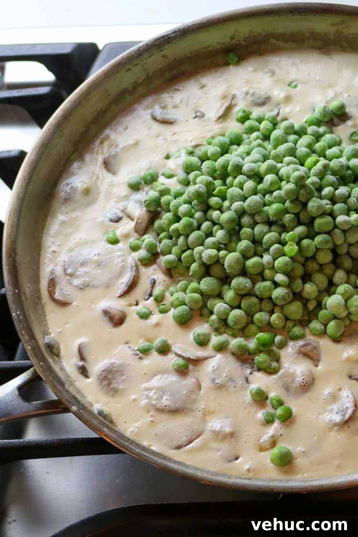 Tuna Noodle Casserole from Scratch (No Canned Soup) 3 creamy mixture with mushrooms and peas added on top.