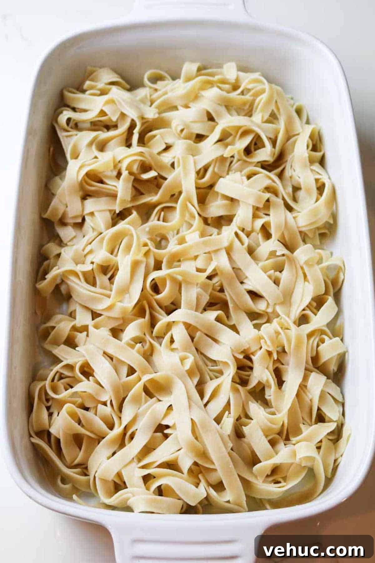 Tuna Noodle Casserole from Scratch (No Canned Soup) 5 egg noodles in white baking dish.