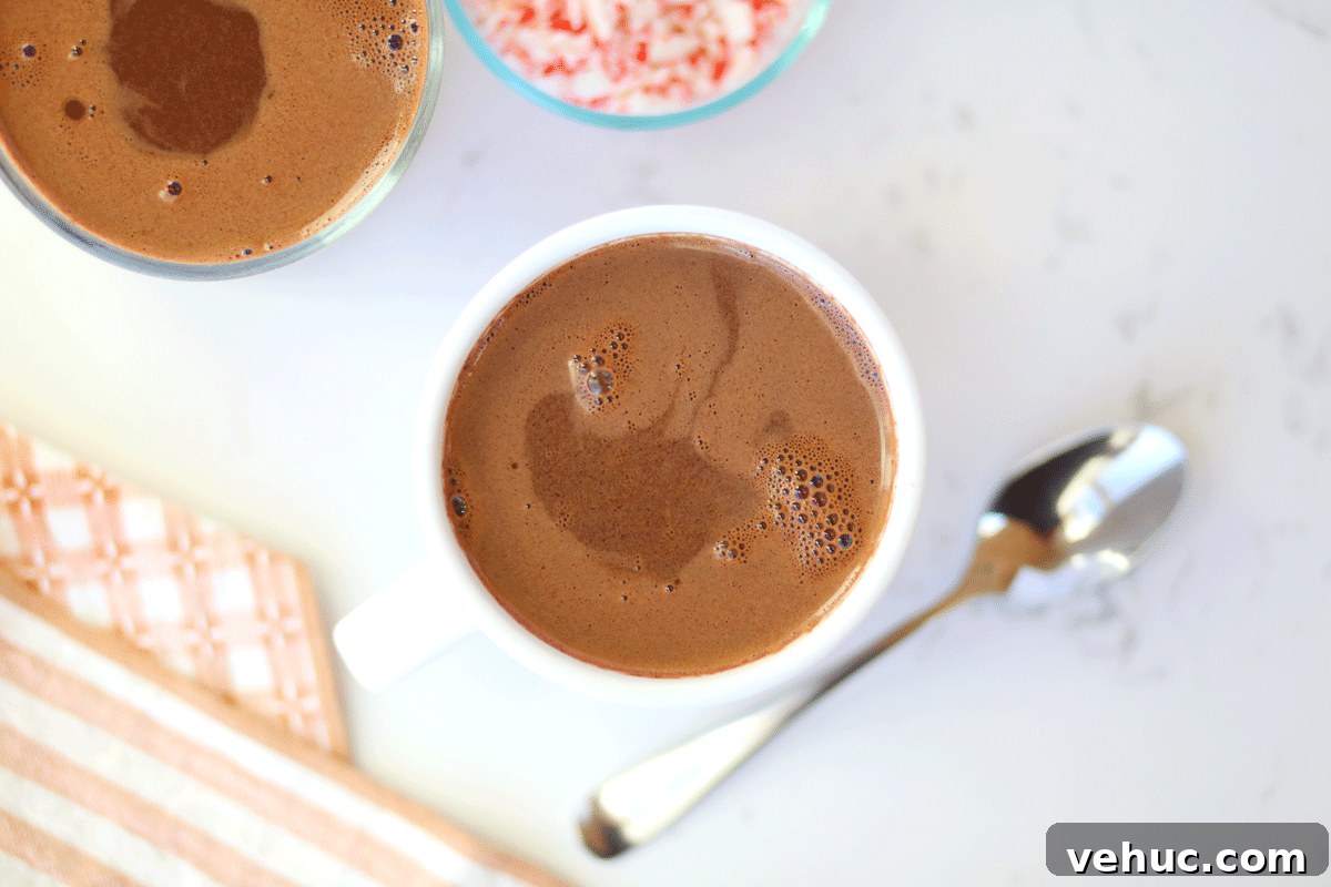 Creamy Homemade Peppermint Hot Chocolate Recipe 5 A mug of cocoa with crushed candy canes next to it