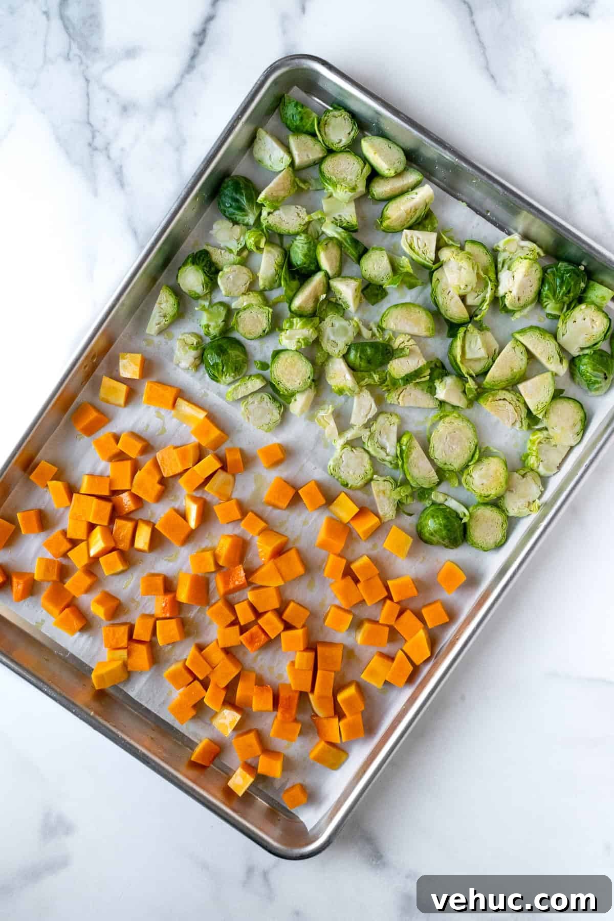 Autumn Harvest Orzo Salad with Roasted Vegetables and Feta 4 Chopped Brussels Sprouts and Butternut Squash on a Baking Sheet.
