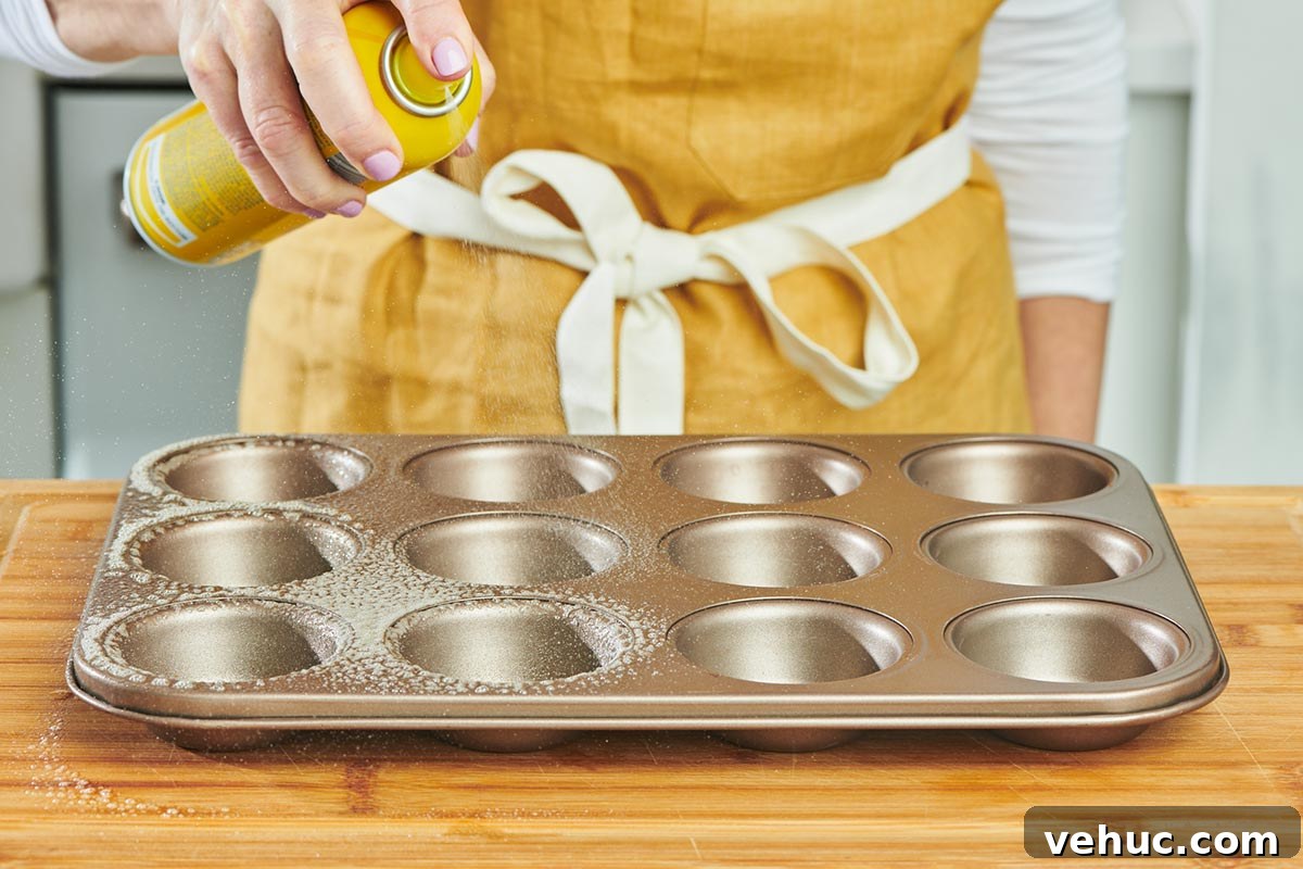 Oven-Baked Eggs: Simple Methods for Perfect Results 3 Woman spraying muffin tin with cooking spray.