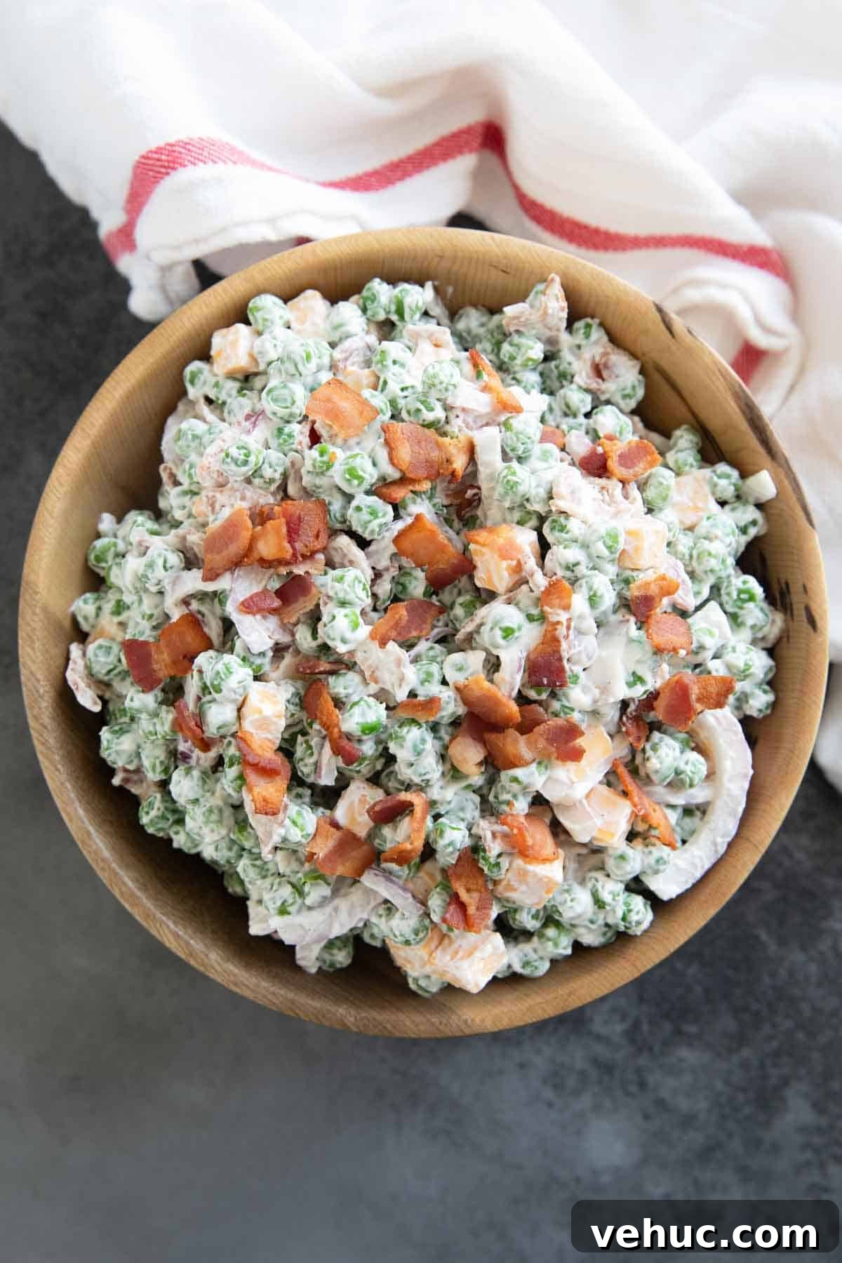 Creamy Pea Salad Recipe with Bacon and Red Onion 2 Pea Salad with bacon and cheese in a large bowl.