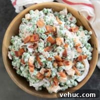 Creamy Pea Salad Recipe with Bacon and Red Onion 8 Pea Salad with bacon and cheese in a large bowl.