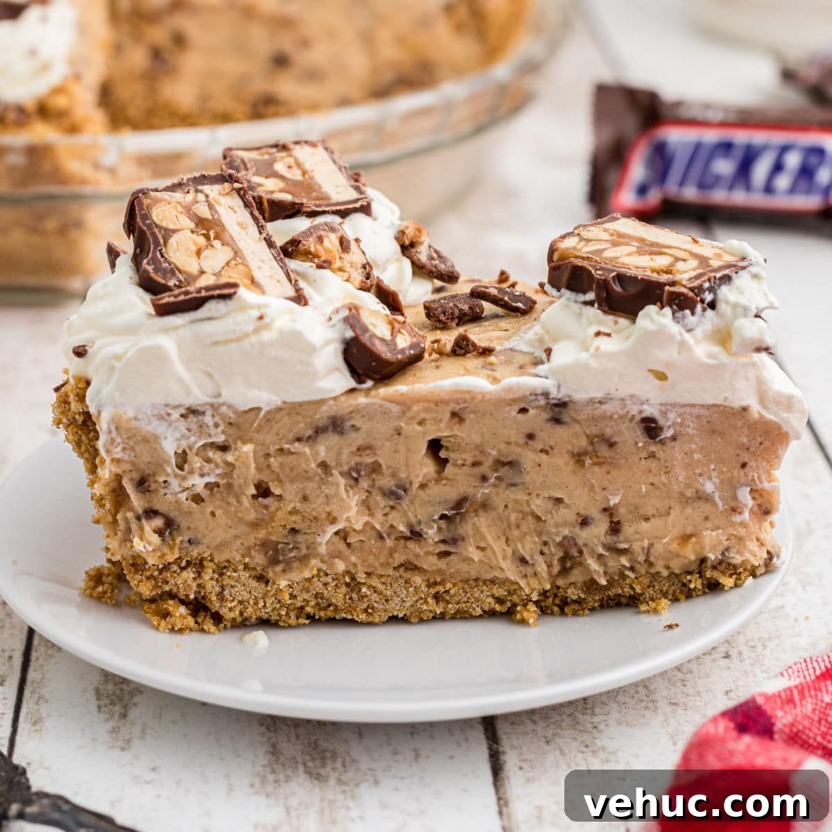 A close up of a slice of no bake snickers pie.