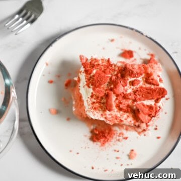 piece of strawberry tres leches cake on a plate.