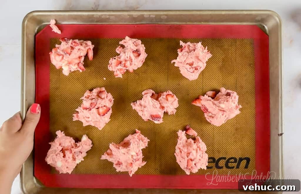 Strawberry Cheesecake Cookies Made with Cake Mix 6 strawberry cookie dough on a baking pan.
