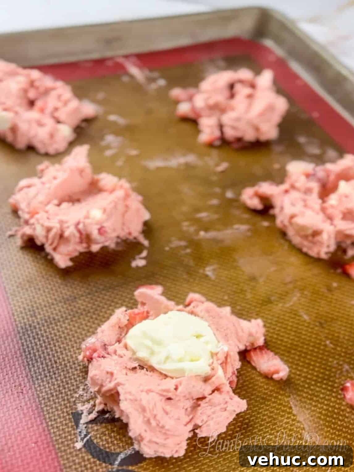 Strawberry Cheesecake Cookies Made with Cake Mix 7 cream cheese spoons in middle of cake batter cookie dough.